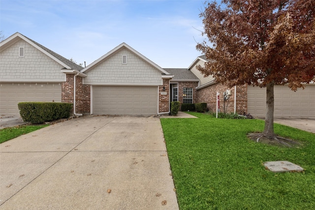 ranch-style house featuring a garage and a front lawn