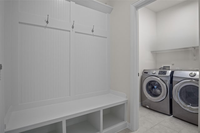 laundry room featuring separate washer and dryer and light tile patterned floors