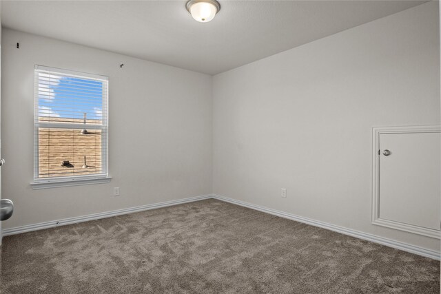 carpeted bedroom with a raised ceiling, ceiling fan, and crown molding