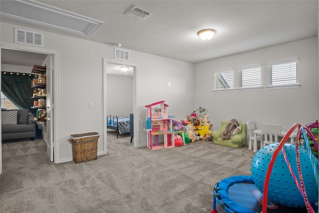 recreation room featuring plenty of natural light, light colored carpet, and a textured ceiling