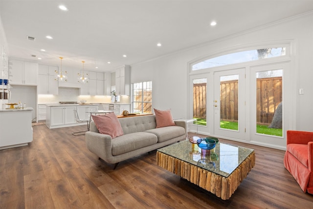 living room with ornamental molding and dark hardwood / wood-style floors