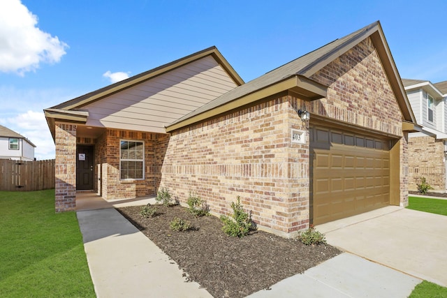 view of front facade featuring an attached garage, driveway, fence, and brick siding