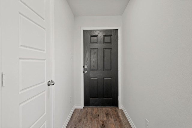 entryway featuring dark wood-style floors and baseboards