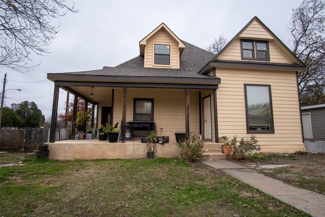 view of front of house featuring a porch and a front lawn