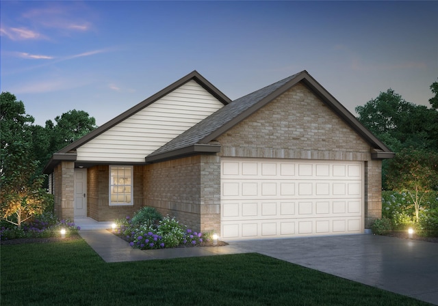 view of front facade with a garage and a lawn