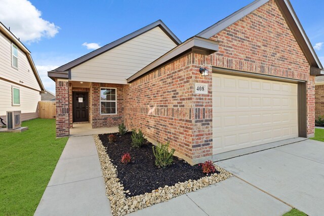 front facade with a garage and central AC unit