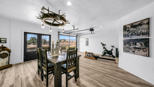 dining room with hardwood / wood-style floors, electric panel, and french doors