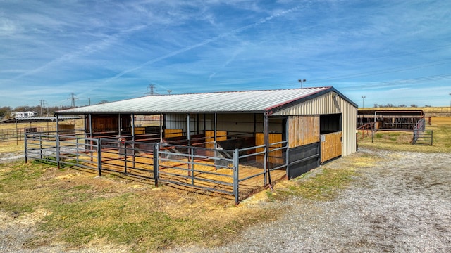 view of stable featuring a rural view