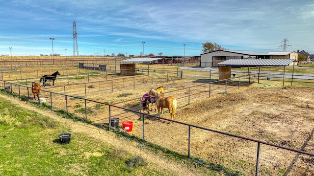 view of yard with a rural view and an outdoor structure