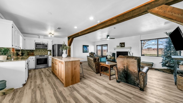 737 Green Branch Rd, Weatherford, TX 76085 - kitchen featuring appliances with stainless steel finishes, healthy amount of natural light, light wood-style flooring, a center island, and recessed lighting