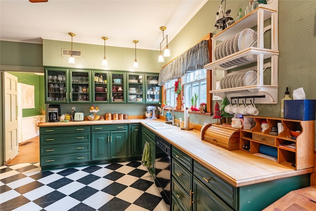 kitchen featuring pendant lighting, sink, dishwasher, and green cabinetry