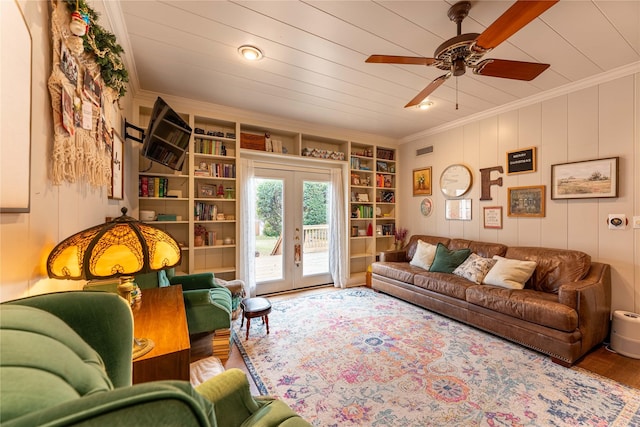 living room with hardwood / wood-style floors, french doors, ornamental molding, ceiling fan, and built in shelves