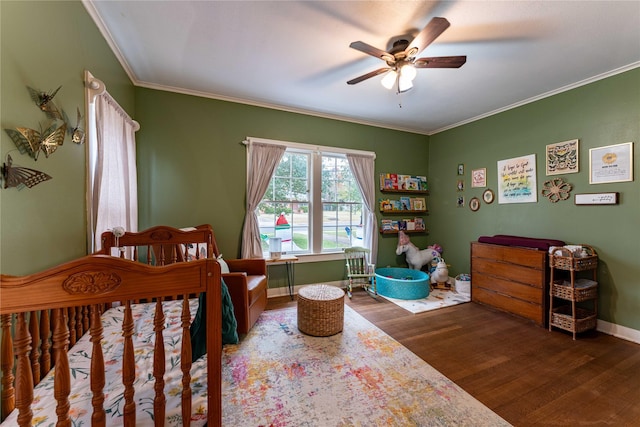 bedroom featuring crown molding, wood-type flooring, and ceiling fan