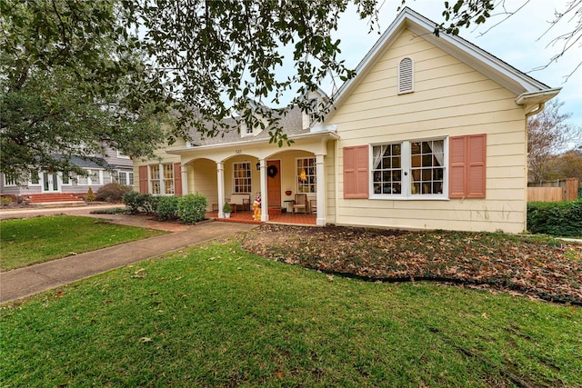 view of front of home with covered porch and a front yard