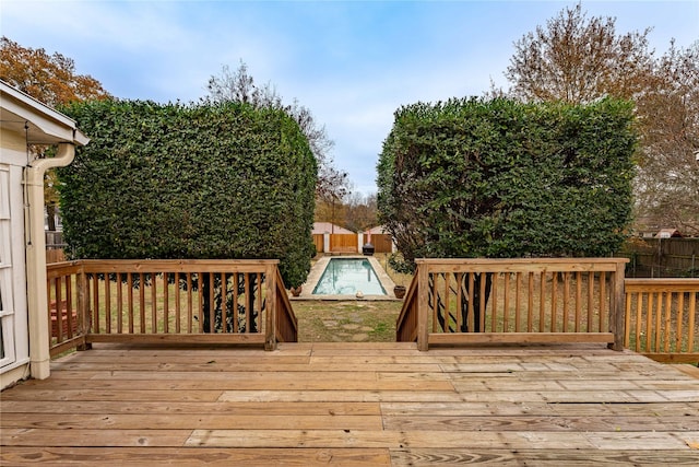 wooden deck featuring a fenced in pool