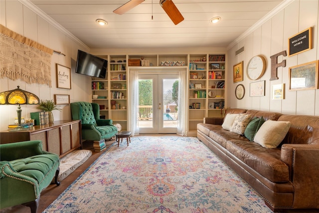 living room with french doors, hardwood / wood-style flooring, ornamental molding, ceiling fan, and built in shelves