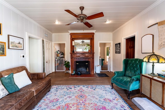 living room with dark hardwood / wood-style flooring, crown molding, and a fireplace