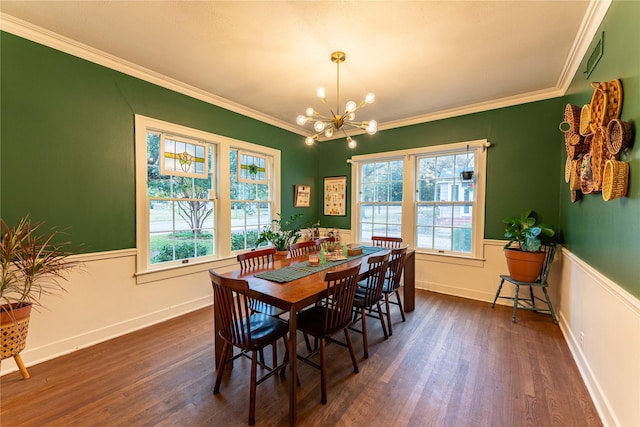 dining space featuring crown molding, dark wood-type flooring, and a chandelier