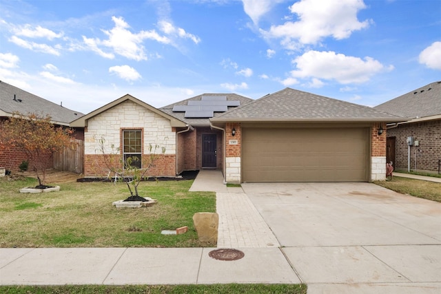 ranch-style house with solar panels, a garage, and a front lawn