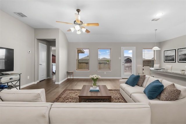 living room with visible vents, a ceiling fan, wood finished floors, and a wealth of natural light