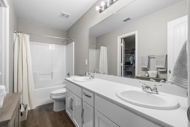 full bathroom featuring shower / bath combo, vanity, hardwood / wood-style flooring, and toilet