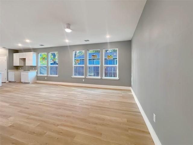 unfurnished living room featuring light wood-type flooring