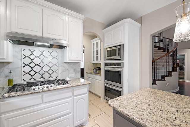 kitchen featuring stainless steel appliances and white cabinets