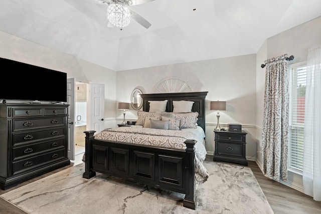 bedroom featuring lofted ceiling and light hardwood / wood-style flooring