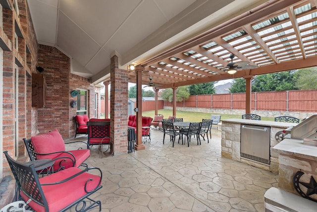 view of patio with an outdoor kitchen, ceiling fan, and a pergola