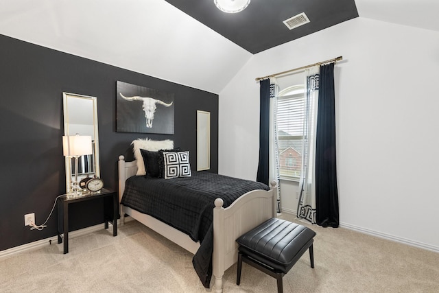 bedroom with light colored carpet and vaulted ceiling