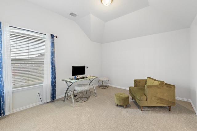 home office with lofted ceiling and light carpet