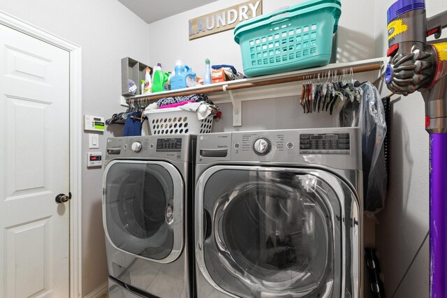 clothes washing area featuring independent washer and dryer