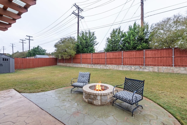 view of patio / terrace featuring a storage unit and an outdoor fire pit