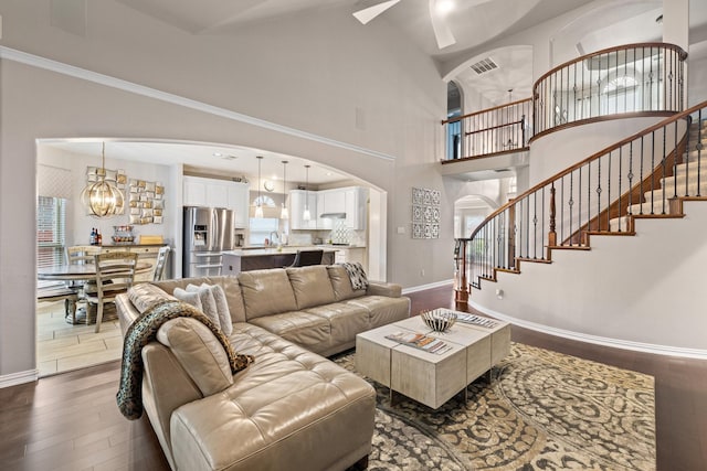 living room featuring sink, dark hardwood / wood-style flooring, and high vaulted ceiling