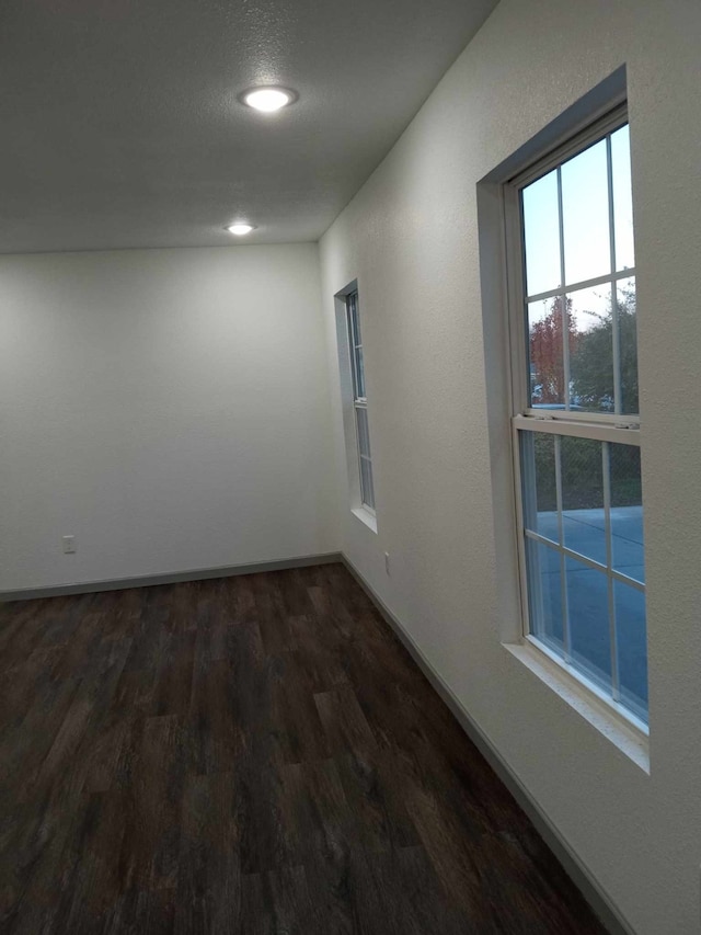 unfurnished room featuring dark hardwood / wood-style floors