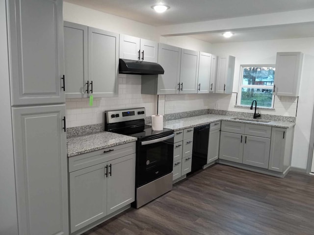 kitchen with sink, dark wood-type flooring, black dishwasher, light stone countertops, and stainless steel electric stove