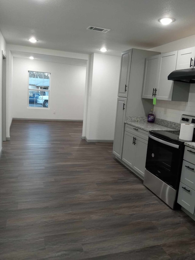 kitchen with white cabinetry, electric range, dark hardwood / wood-style flooring, and decorative backsplash