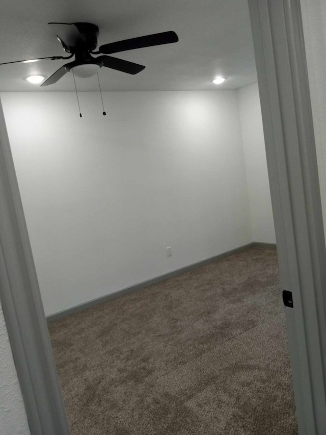 carpeted empty room featuring ceiling fan