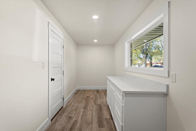 corridor with dark hardwood / wood-style flooring