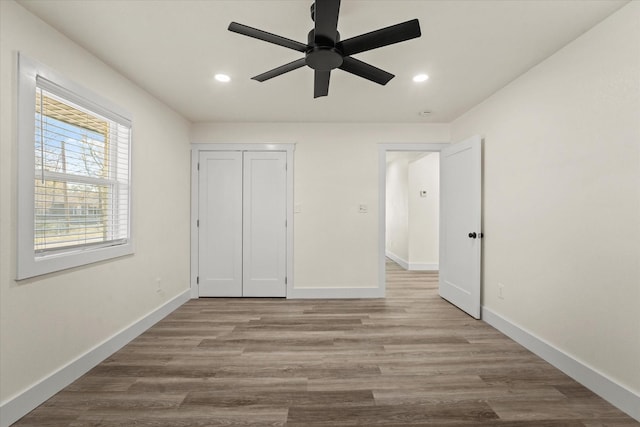 unfurnished bedroom with ceiling fan, a closet, and light hardwood / wood-style flooring