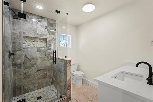 bathroom with toilet, vanity, tile patterned floors, and a shower with shower door