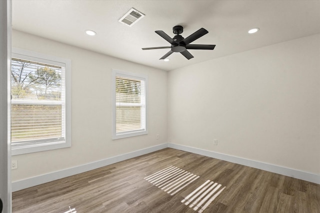 spare room featuring ceiling fan and hardwood / wood-style flooring