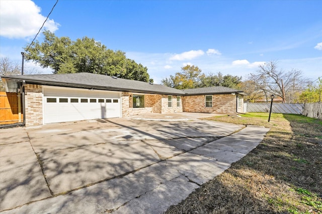 ranch-style home with a front yard and a garage