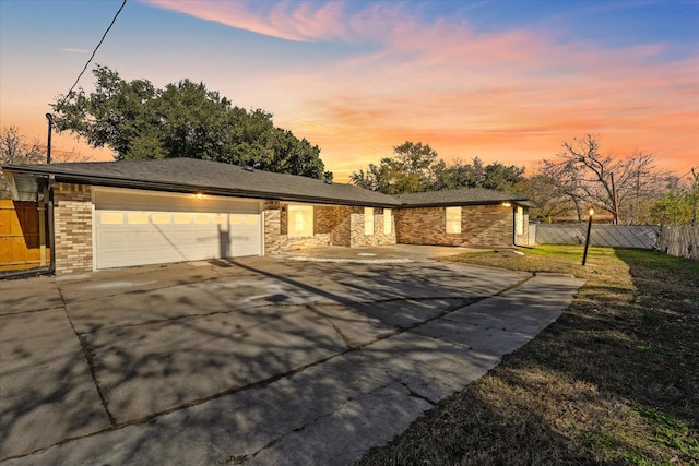 view of front of house with a yard and a garage