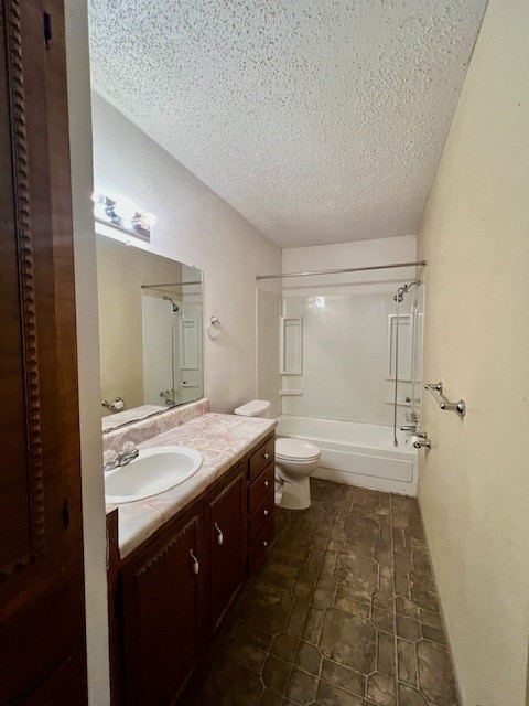 full bathroom with vanity, toilet, shower / bath combination, and a textured ceiling