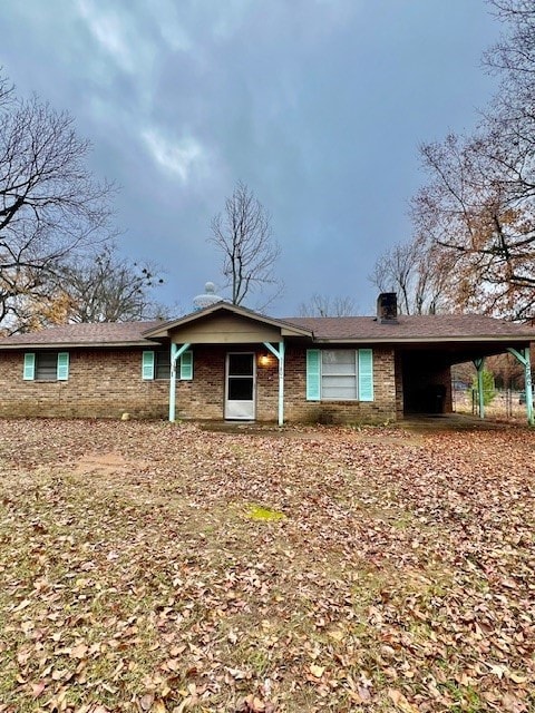 ranch-style house featuring a carport