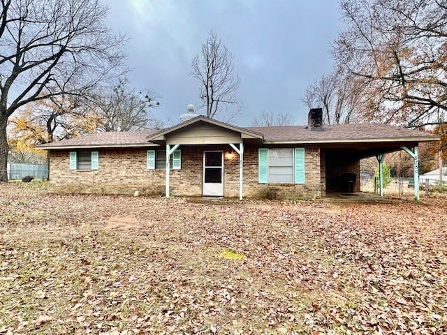 single story home featuring a carport