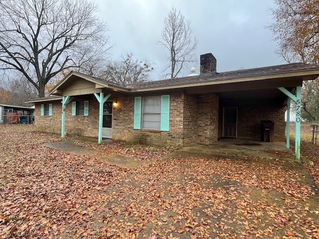 rear view of house with a carport