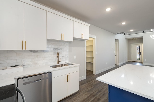 kitchen featuring white cabinets, sink, stainless steel dishwasher, dark hardwood / wood-style floors, and light stone counters