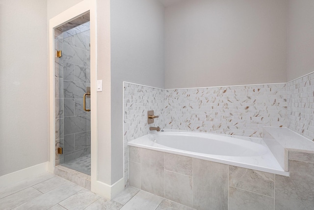 bathroom featuring tile patterned flooring and independent shower and bath